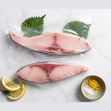 Load image into Gallery viewer, Frozen premium Yellowtail Hamachi portions in vacuum-sealed packaging with shiso and lemon garnish