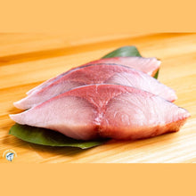 Load image into Gallery viewer, Sliced raw Yellowtail Hamachi fanned on shiso leaf showing pink flesh and marbling