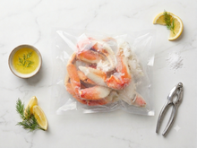 Load image into Gallery viewer, Frozen Dungeness crab sections in vacuum-sealed bag with butter and lemon
