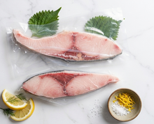 Load image into Gallery viewer, Frozen premium Yellowtail Hamachi portions in vacuum-sealed packaging with shiso and lemon garnish
