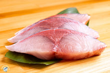 Load image into Gallery viewer, Sliced raw Yellowtail Hamachi fanned on shiso leaf showing pink flesh and marbling
